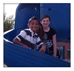 Students pose on a playground slide
